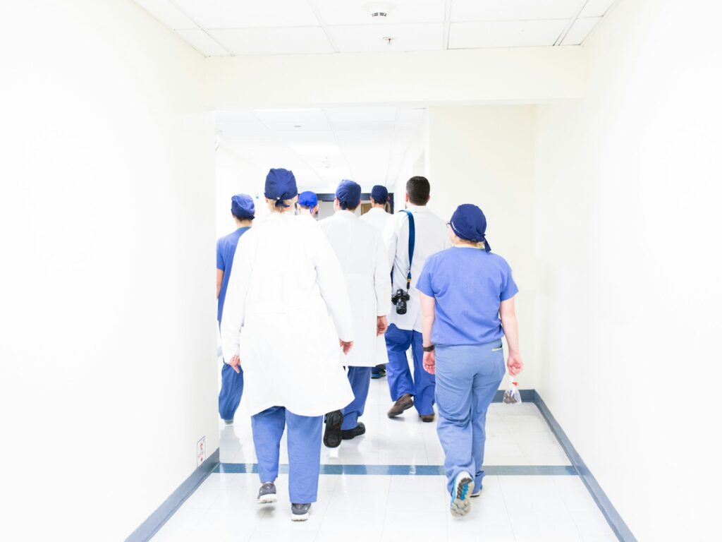 Team of healthcare professionals walking through a hospital hallway